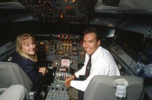 Pilots smiling in the cockpit of a plane