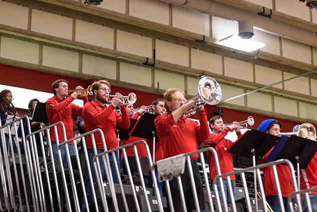 Pep Band members playing brass instruments on risers